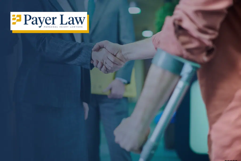 man with crutches shaking hands with an attorney