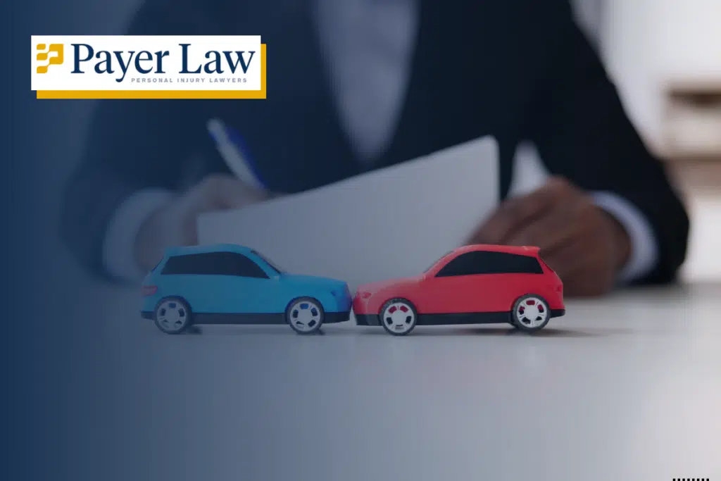 person writing on a paper with two cars in front