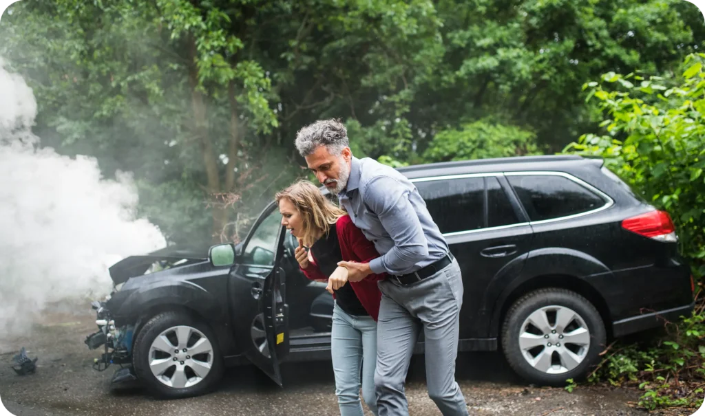 a man helping a woman after a car accident