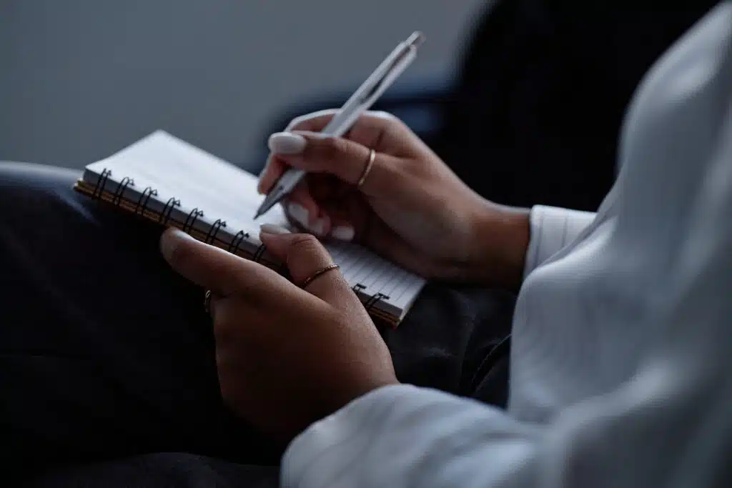 a woman journaling her injuries after a car accident